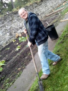 Tommy peels back the sod for bulb planting